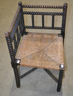 Lot 1049 - A 19th century corner bobbin chair with wicker...