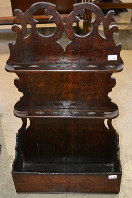 Lot 1052 - A 19th century oak spoon rack with shaped back...
