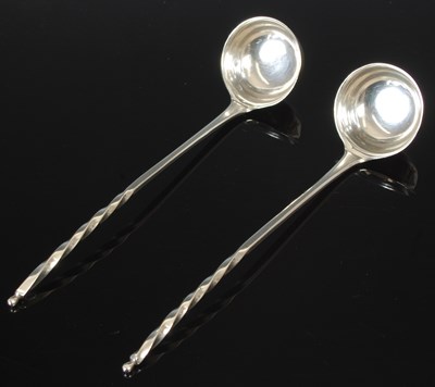 Lot 203 - A pair Scottish provincial silver toddy ladles,...
