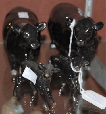 Lot 13 - A Beswick Aberdeen Angus black bull, cow and...
