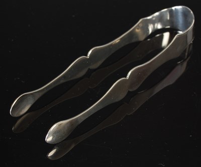 Lot 99 - An unusual pair of Colonial silver sugar tongs,...