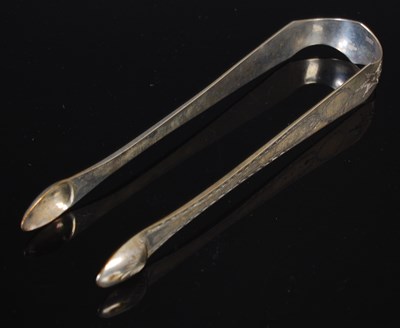 Lot 102 - A pair of Irish provincial silver sugar tongs,...