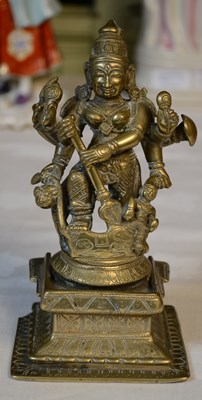 Lot 774 - A brass statue of a Hindu deity standing with...