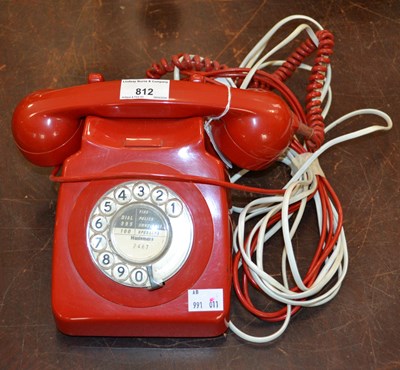 Lot 812 - A vintage rotary dial red desk phone,...