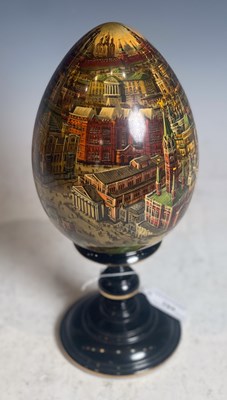 Lot 704 - A Russian hand painted wooden egg, featuring...