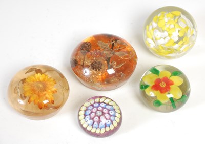 Lot 671 - A group of five glass paperweights, to include...