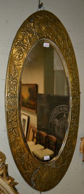 Lot 1031 - A late 19th century oval brass mirror in the...