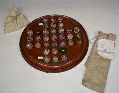 Lot 834 - A 19th century mahogany solitaire board with a...