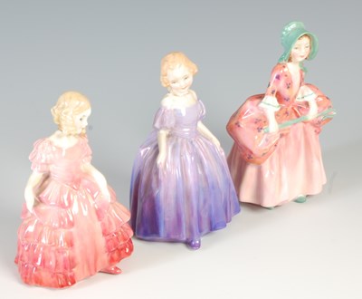 Lot 639 - A group of three Royal Doulton ceramic figures,...