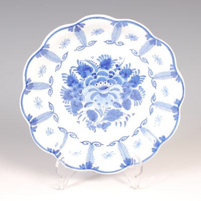 Lot 646 - A Delft ceramic plate, having scalloped edges,...