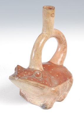 Lot 650 - A stirrup spout vessel in the form of a frog,...
