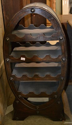 Lot 1178 - A 20th century plywood wine rack of oval form,...