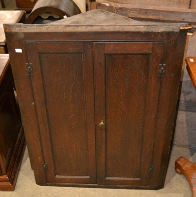 Lot 1193 - A 19th century oak hanging corner cupboard,...