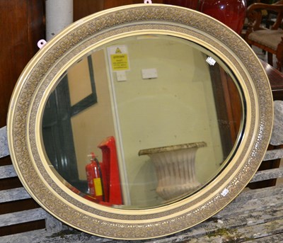 Lot 1032A - An early 20th century oval mirror, the glass...