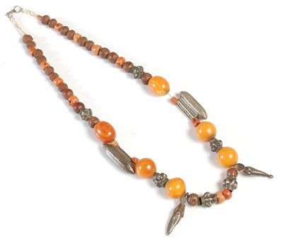 Lot 304 - An amber, white metal, coral and nut bead...