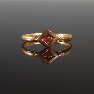 Lot 335 - An 18ct gold and garnet set single stone ring,...