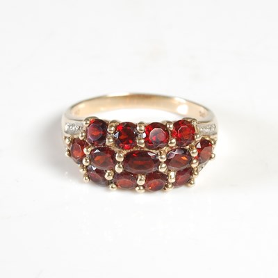 Lot 346 - A yellow metal and garnet set ring, stamped...