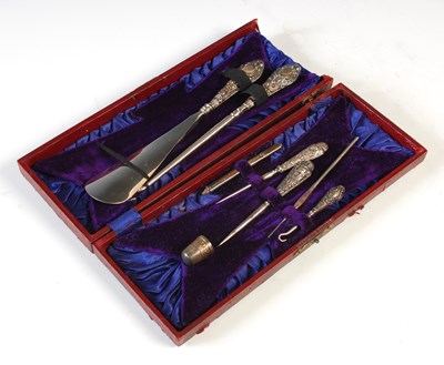 Lot 293 - A cased silver handled manicure set, with...