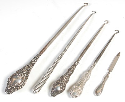 Lot 294 - Four various silver handled button hooks and a...