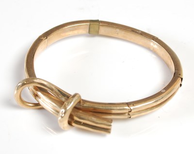 Lot 376 - An articulated yellow metal part bangle, tests...