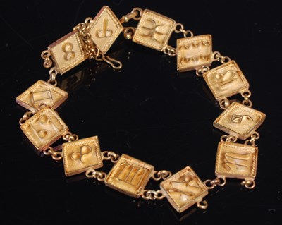 Lot 384 - A yellow metal zodiac panel bracelet (some...
