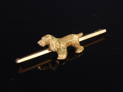 Lot 409 - A vintage yellow metal bar brooch, centred...