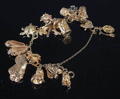 Lot 412 - A vintage 9ct gold charm bracelet, gross...