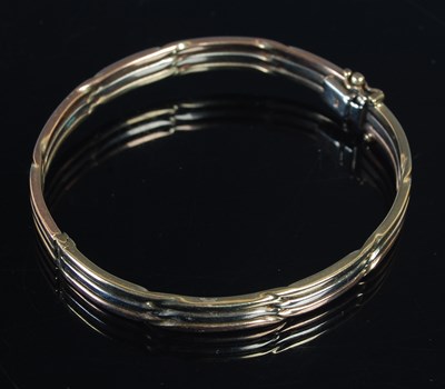 Lot 437 - A three colour 9ct gold hinged bangle, 63.8mm...