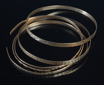 Lot 443 - A group of five assorted 9ct gold bangles (1...