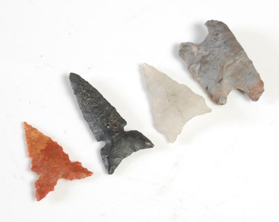 Lot 469 - Three carved stone arrowheads and a section...