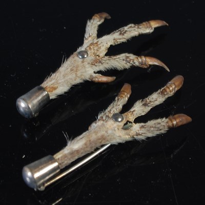 Lot 488 - Two white metal mounted claw brooches....
