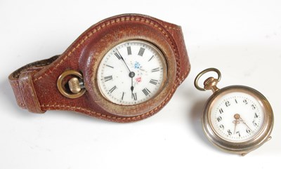 Lot 527 - A fob watch in brown leather mount strap...