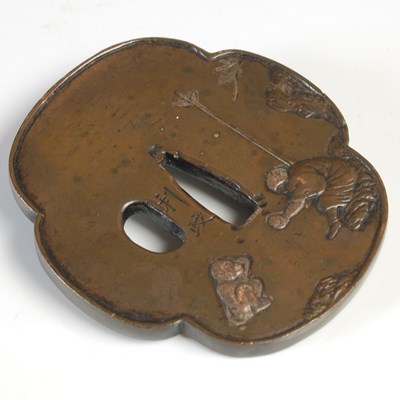 Lot 608 - A Japanese bronze Tsuba, decorated in shallow...