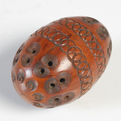 Lot 613 - An antique coquilla nut sewing egg, formed in...