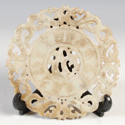 Lot 630 - A Chinese green stone bi disc, probably jade,...