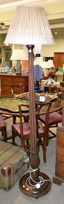 Lot 1170 - A 20th century mahogany floor lamp, with...