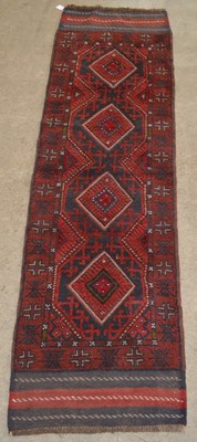 Lot 1218 - A Meshwani runner, the madder ground centred...