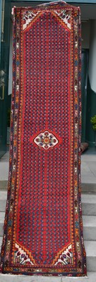 Lot 1224 - A Persian runner, 20th century, the madder...