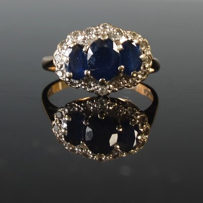 Lot 327 - A 9ct gold sapphire and diamond set dress ring,...