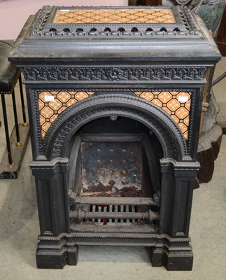Lot 834 - A late 19th century cast iron tiled fireplace...