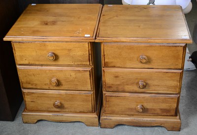 Lot 862 - A pair of pine three drawer bedside chests,...