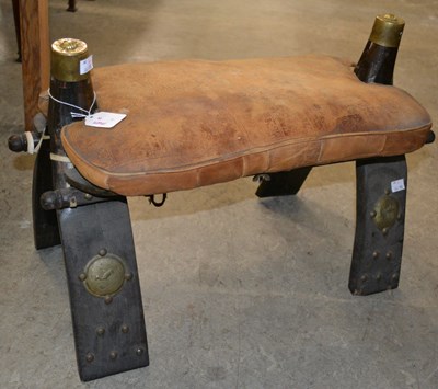 Lot 858 - A 20th century camel saddle stood, featuring a...