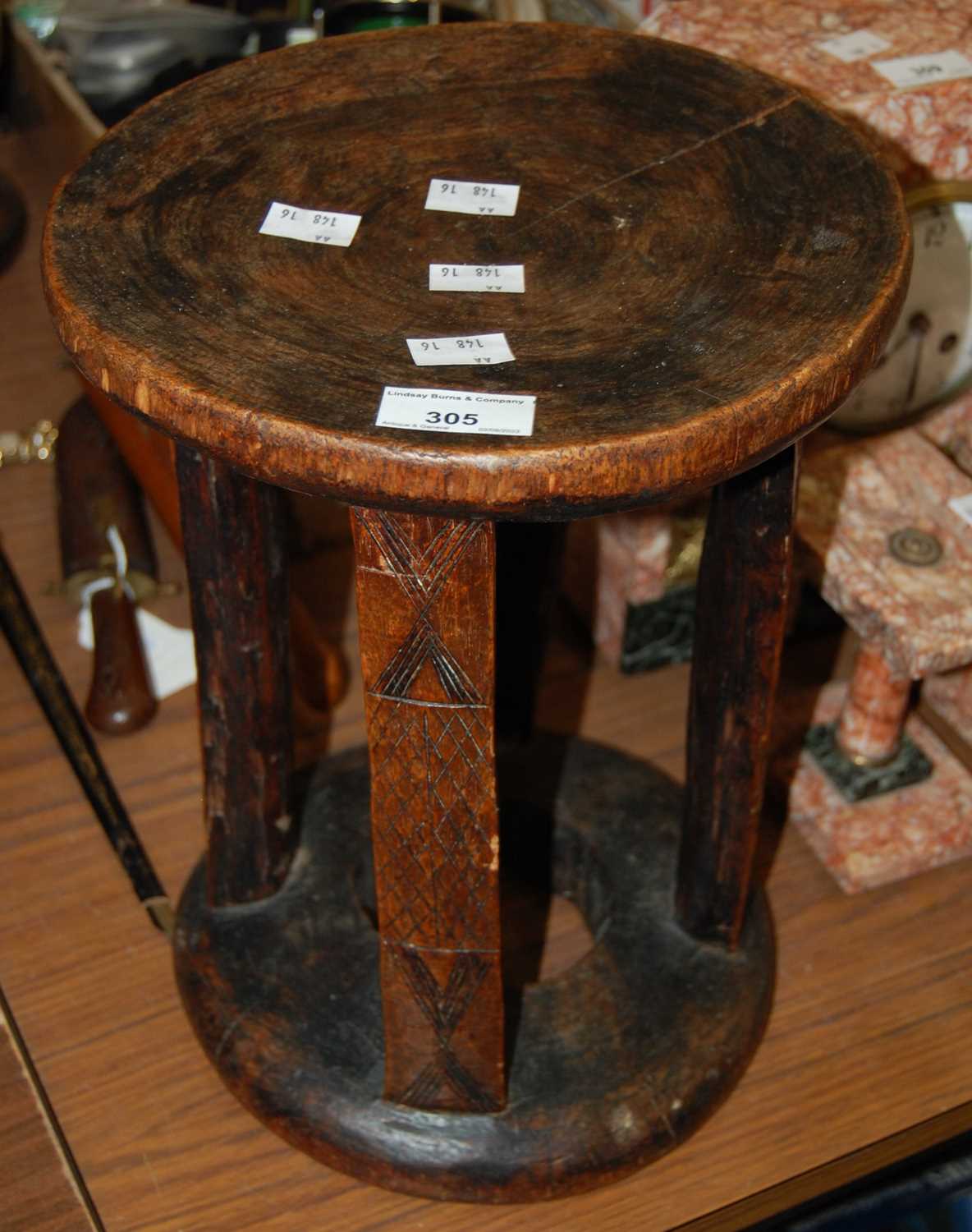 Lot 305 - An African tribal style stool, the circular...