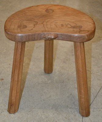 Lot 881 - A three legged stool, by Robert Mouseman...