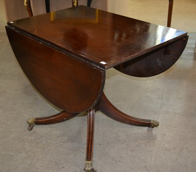 Lot 910 - A reproduction mahogany drop leaf dining table,...