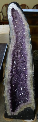 Lot 480 - A large amethyst cathedral geode, with a deep...