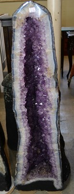 Lot 479 - A large amethyst cathedral geode, with purple...
