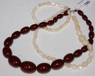 Lot 105 - A red amber type graduated bead necklace,...