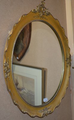 Lot 814 - An early 20th century oval gilt wall mirror,...