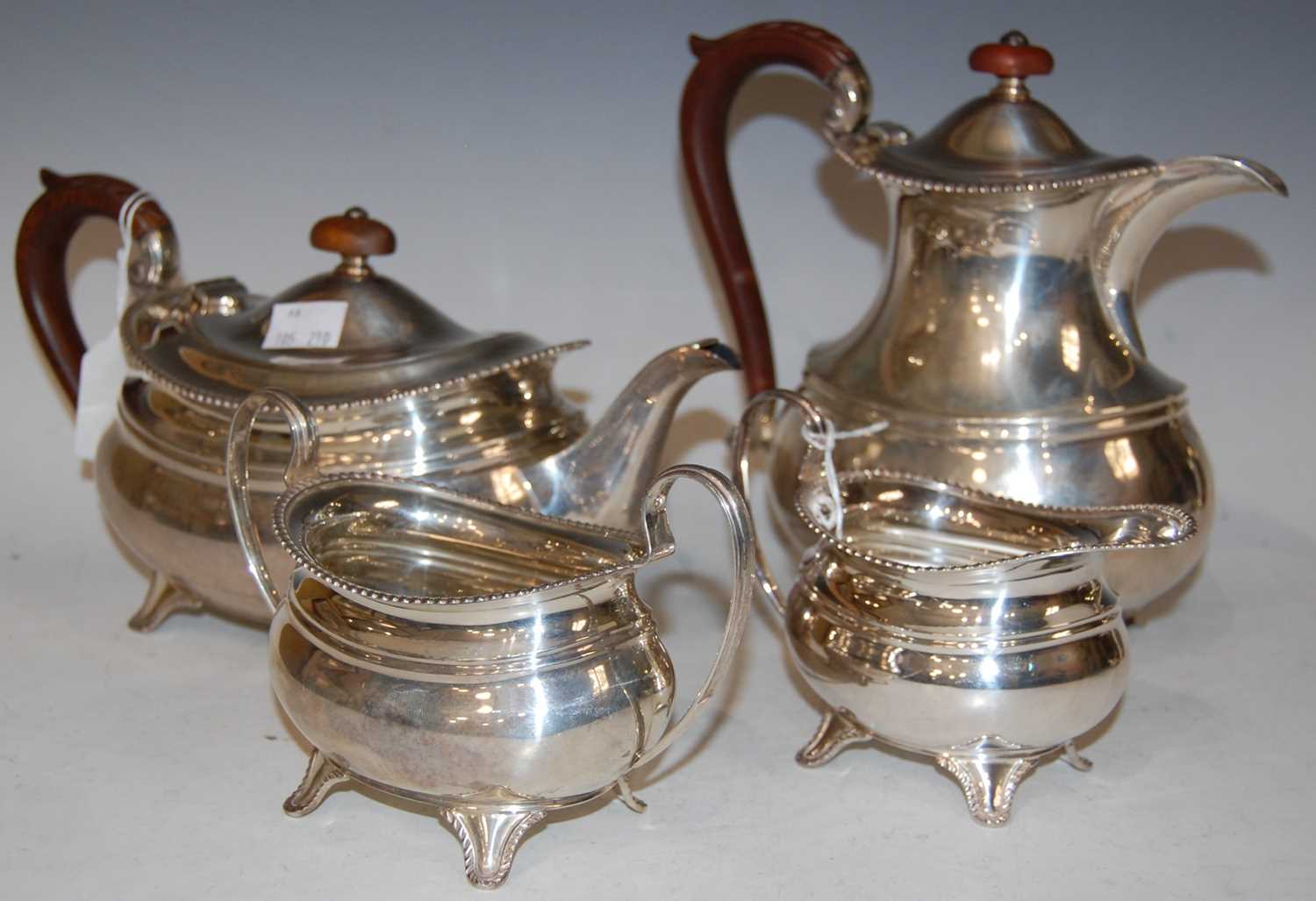 Lot 110 - A George VI silver four-piece silver tea set,...